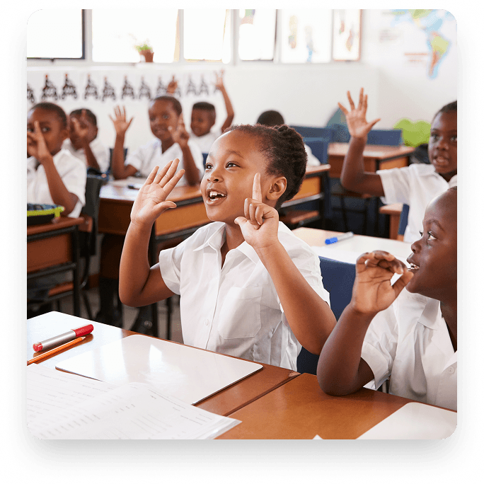 Students raising hands in a private school classroom